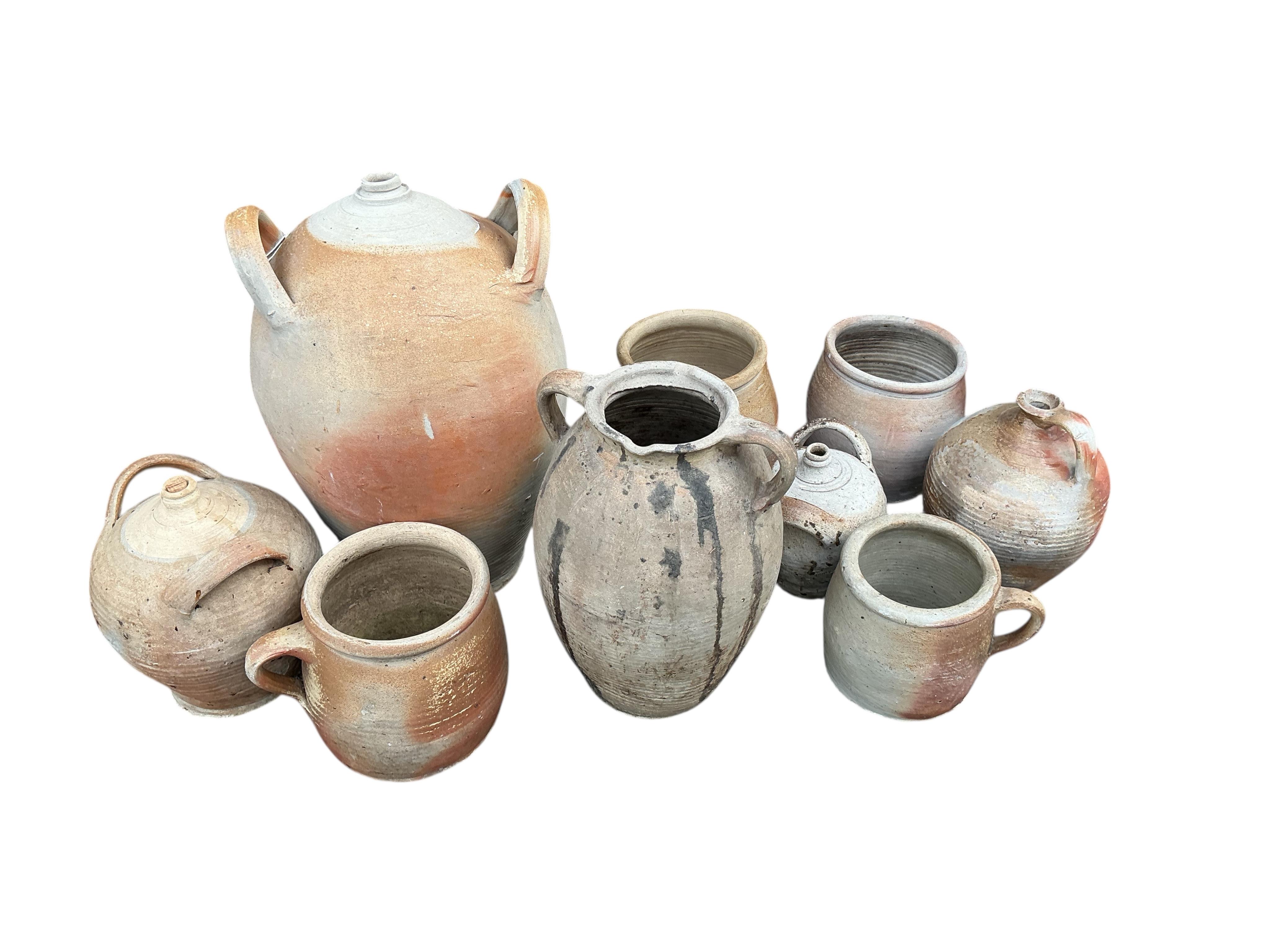 Nine assorted earthenware wine jars and containers, largest height 41cm